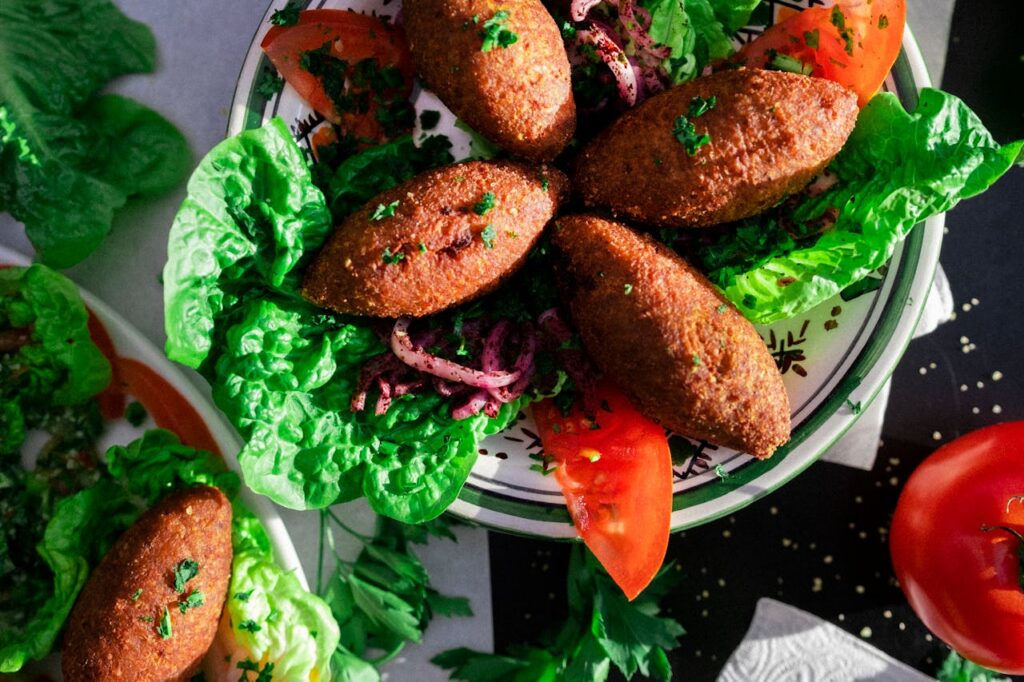 Mastering the First Impression: Your intriguing post title goes here Delicious Lebanese kibbeh served on a bed of fresh greens and vegetables.
